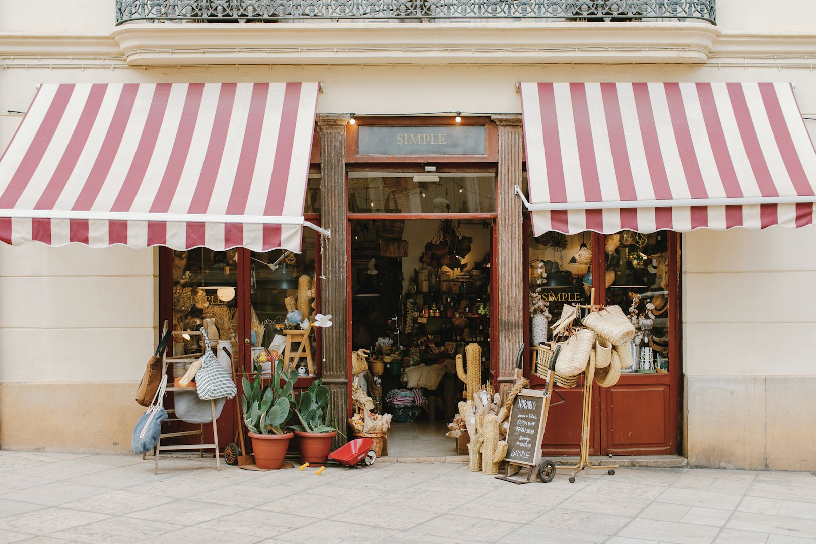 cute store facade with red-white-striped canopies